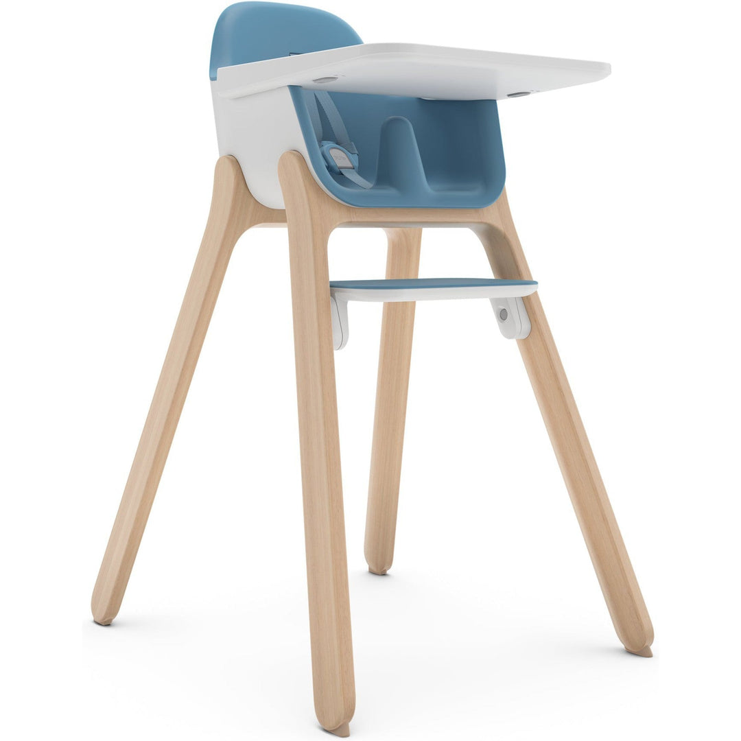 UPPAbaby Ciro high chair in charcoal with wood-tone accents, pulled up to a family dining table