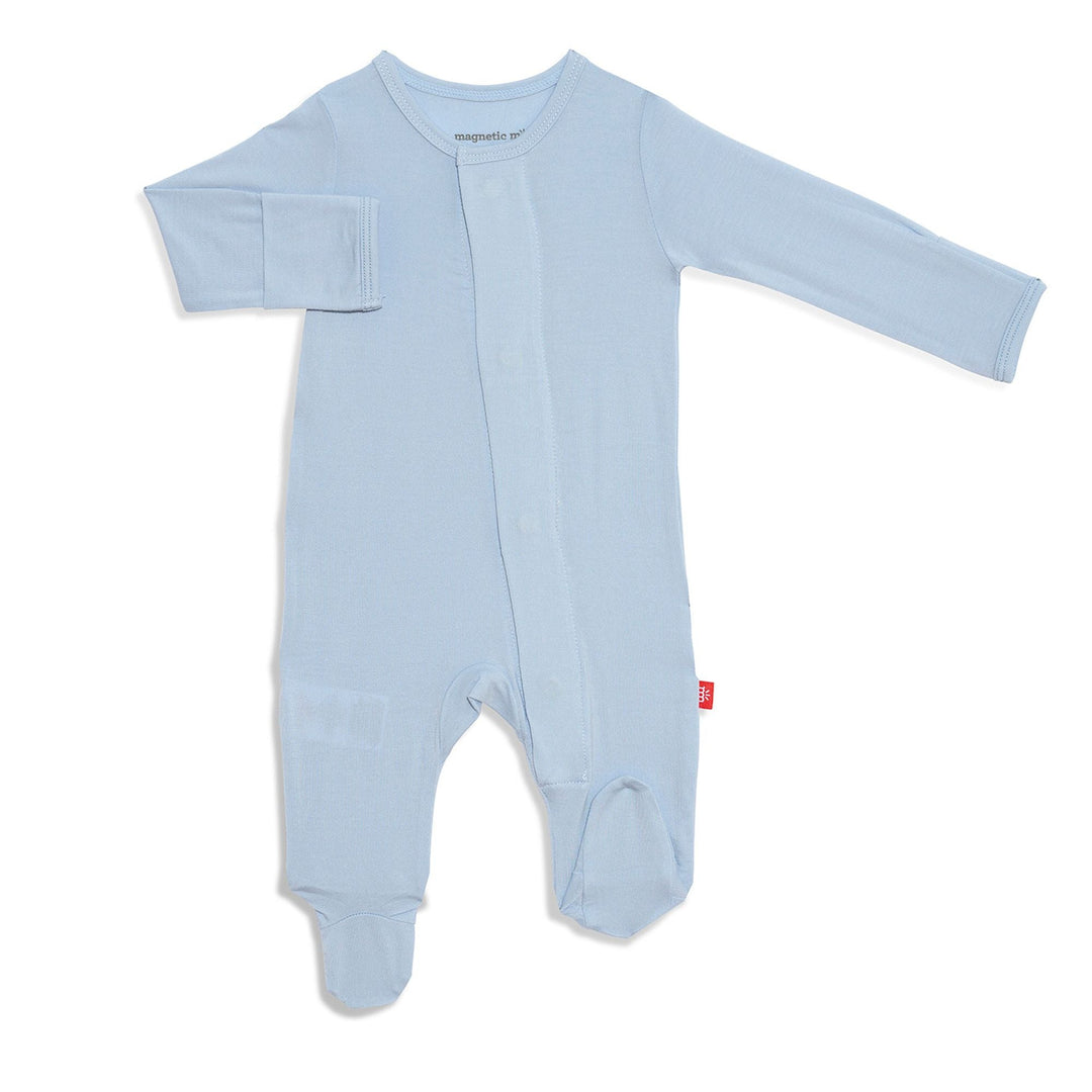 Magnetic Me modal baby footies and convertible coverall laid flat on a soft white surface, showing magnetic closure details, available at Cuddles and Carriages in Evans, Georgia