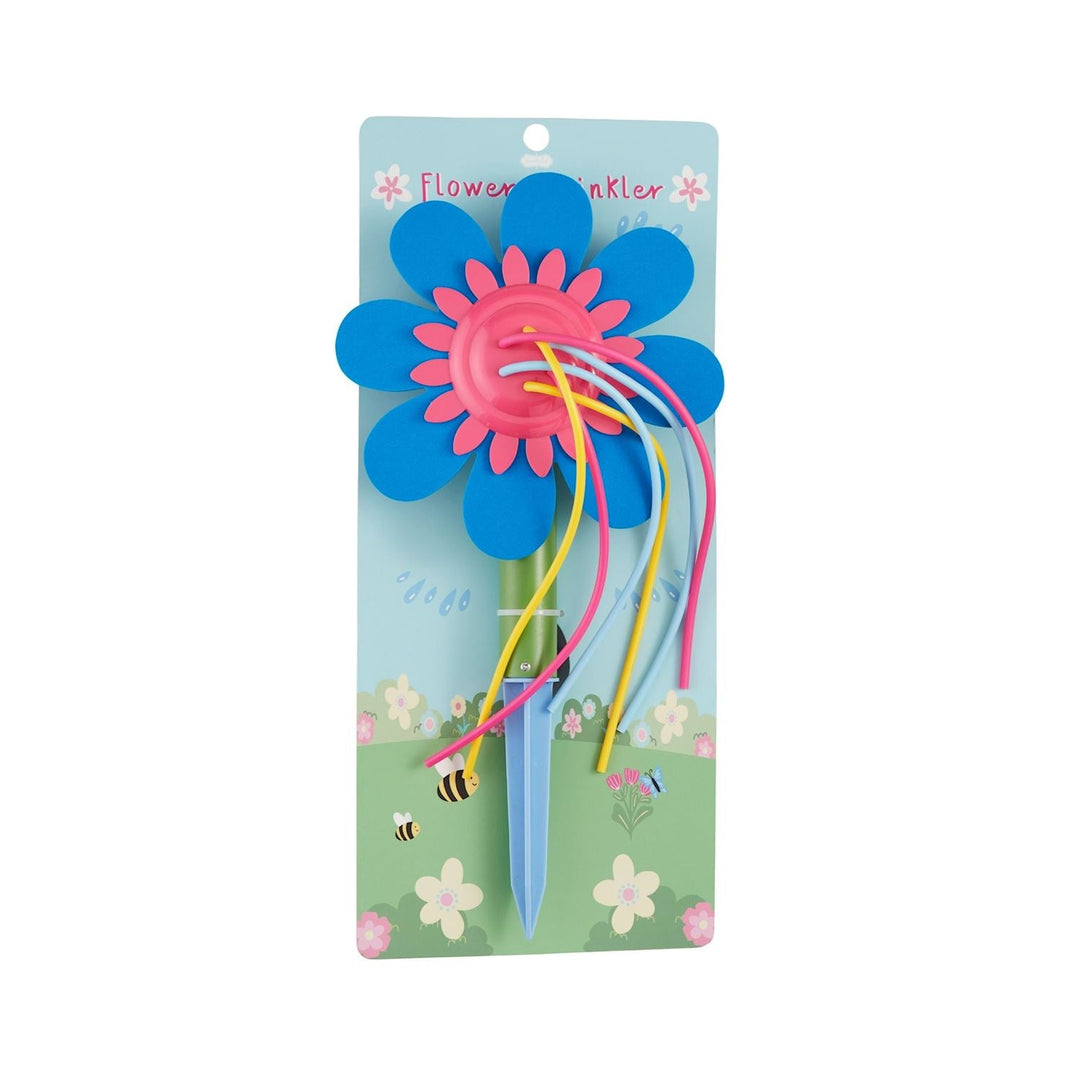 Mud Pie Blue Flower Sprinkler in a sunny backyard, with water arcing from a colorful flower-shaped sprinkler staked into green grass — perfect summer outdoor gift for kids from Cuddles and Carriages in Evans, GA