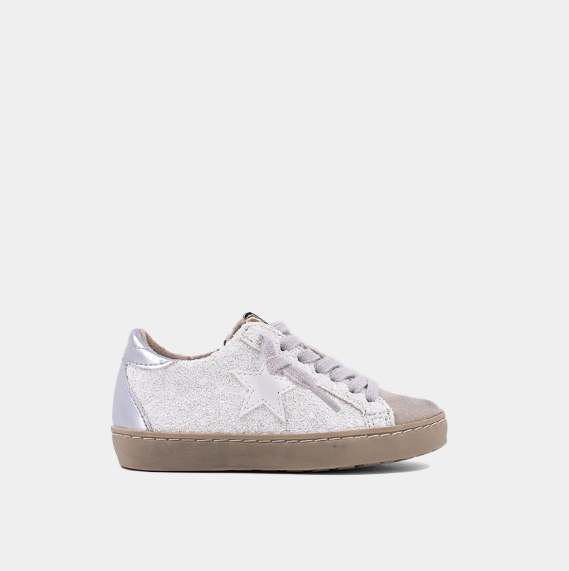 Shu Shop Paula Mini Golden and White Glitter kids sneakers displayed on a wooden surface at Cuddles and Carriages in Evans, GA