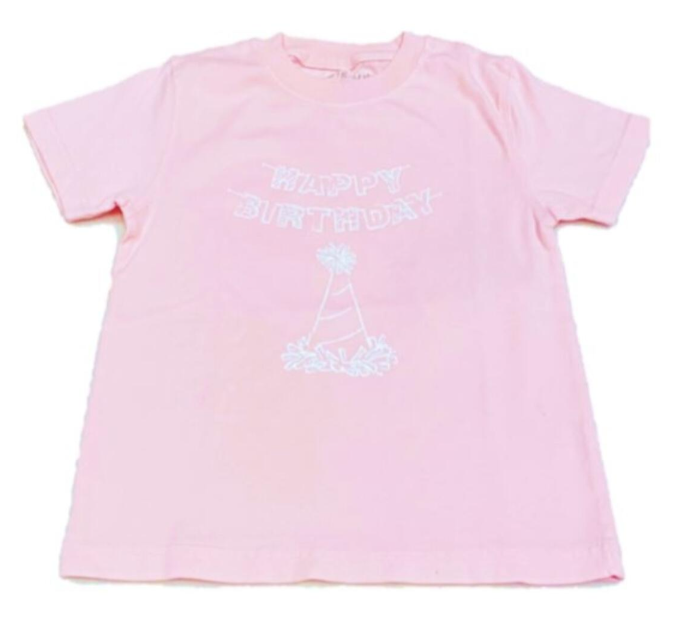 Mustard and Ketchup Kids pink and blue birthday t-shirts laid flat on a white surface, showing the clean front panel and soft garment-dyed cotton fabric, available at Cuddles and Carriages in Evans Georgia