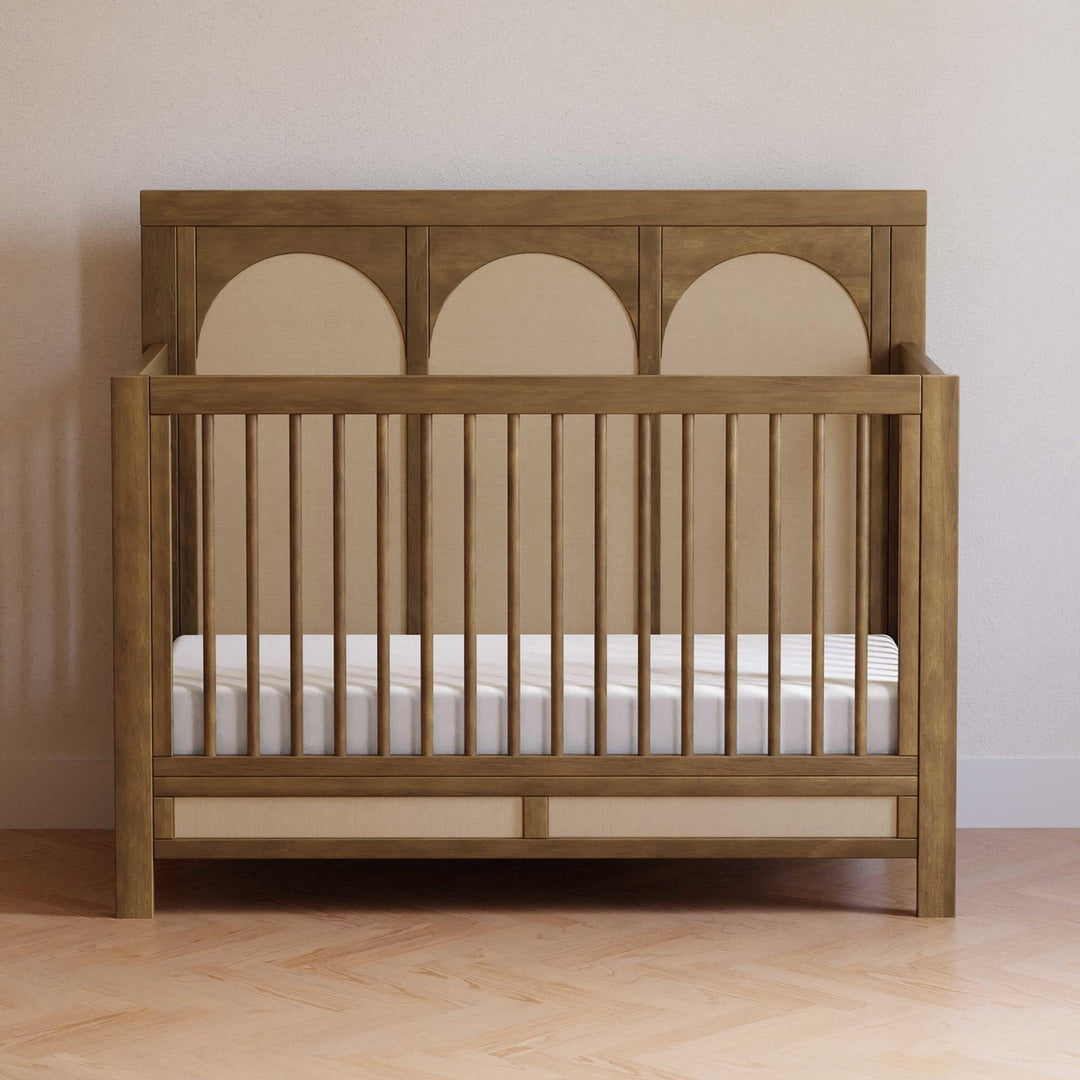Namesake Eloise 4-in-1 convertible crib with an upholstered eco-performance headboard styled in a nursery