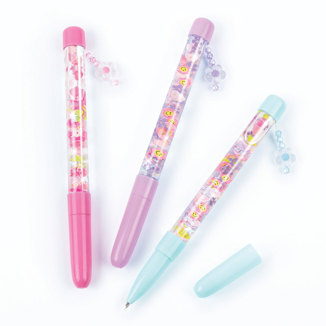 Three colorful pens with cartoon character designs on a white background