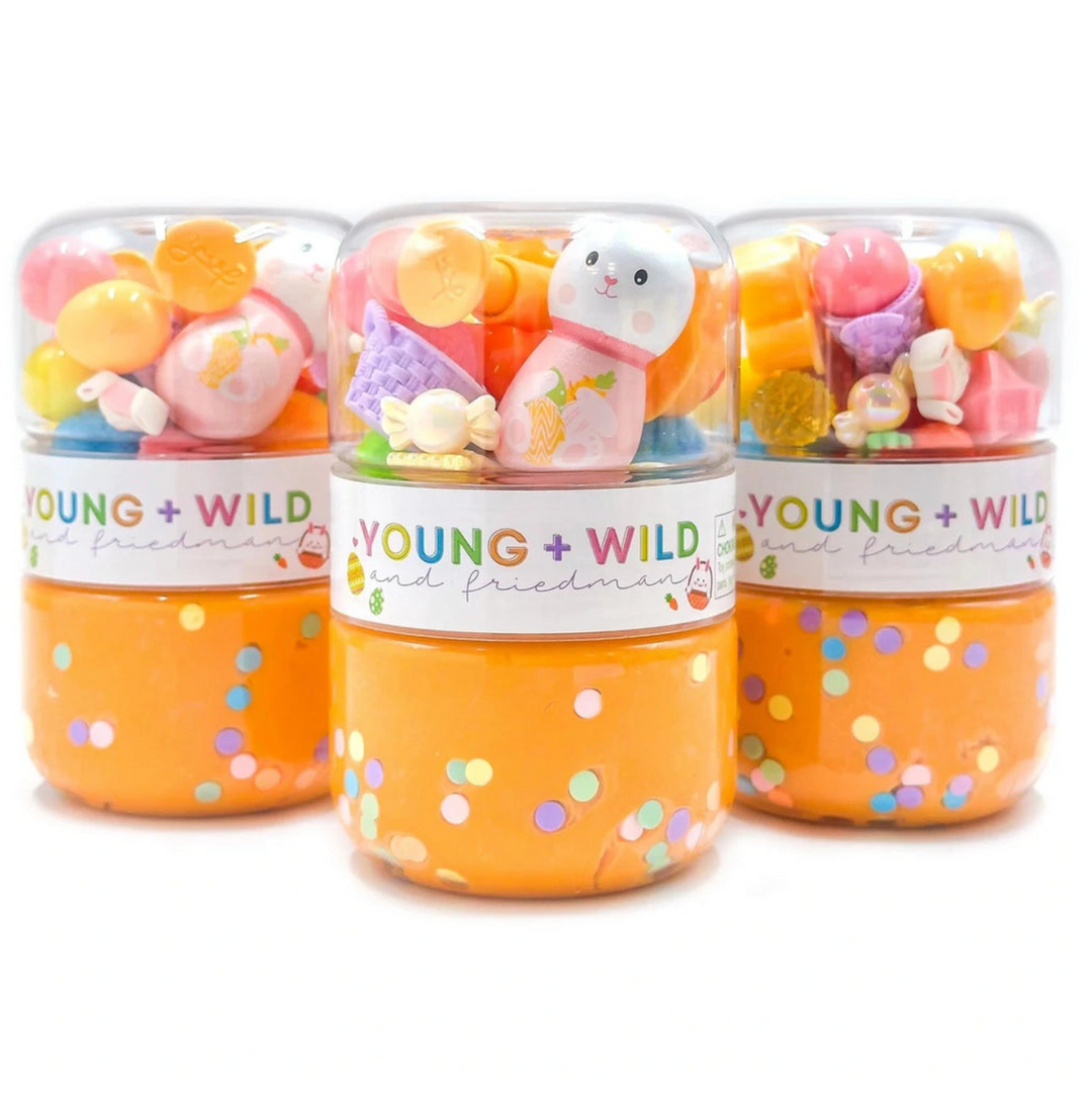 Three small jars filled with colorful candies and a toy bunny,  labeled 'Young + Wild and Friedman', on a white background.
