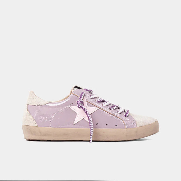 Purple sneaker with a white star on a light gray background