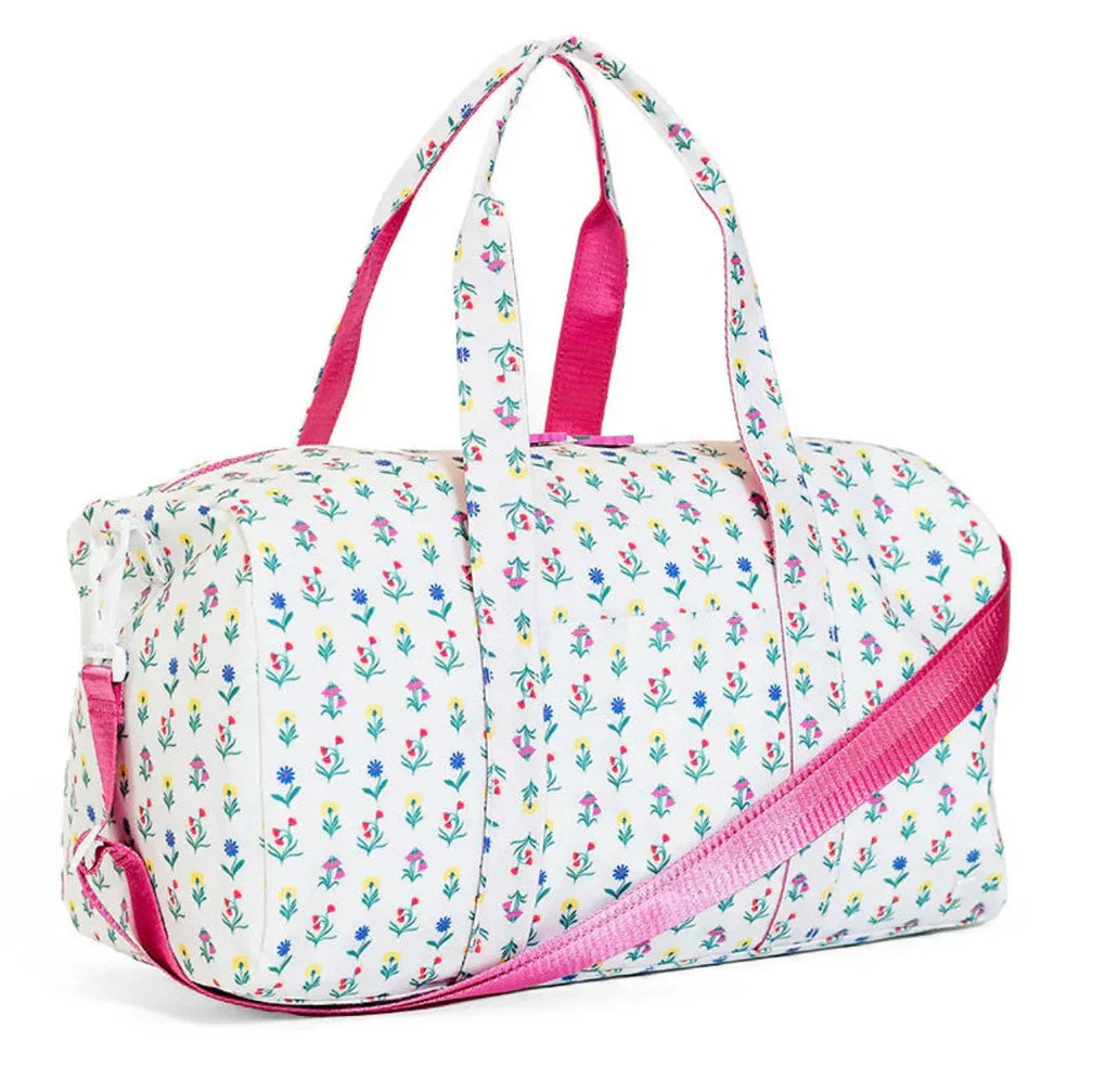 Floral patterned duffel bag with pink accents on a white background