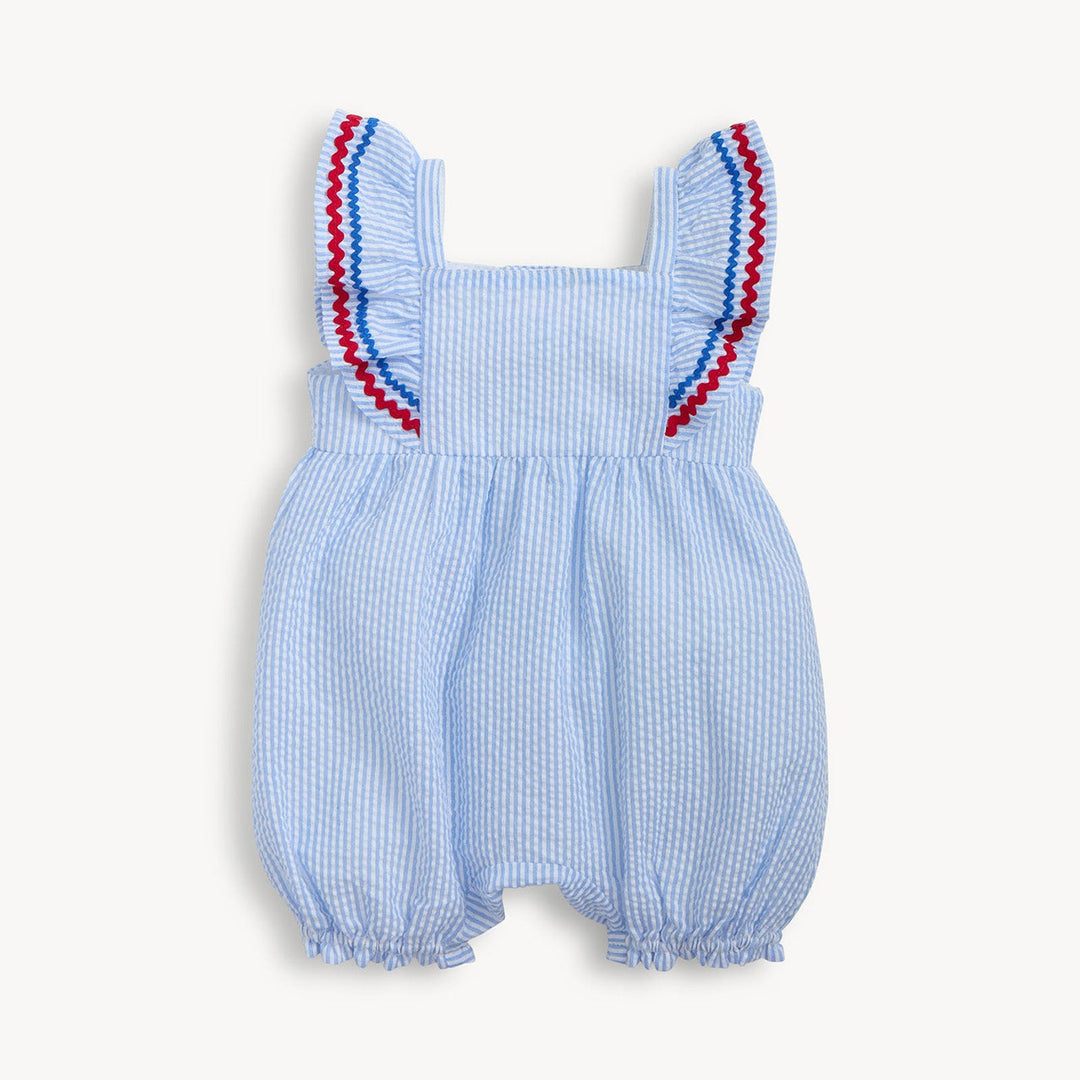 Blue checkered baby romper with red trim on a white background